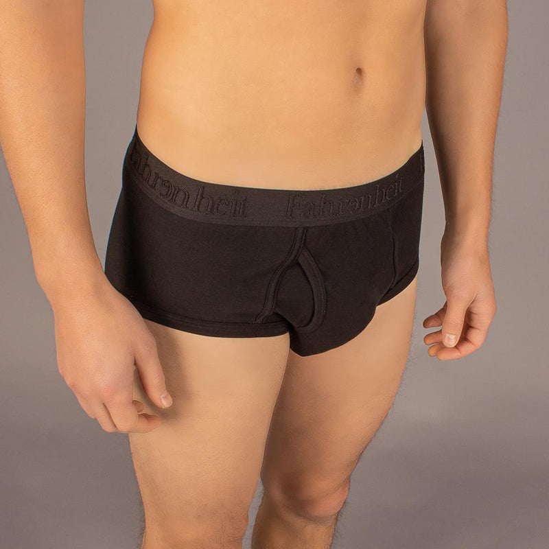 Black boxer briefs with a brand logo on a neutral background