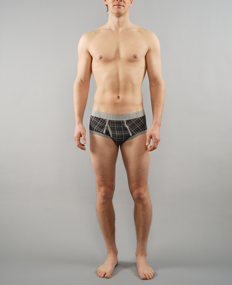 Man wearing plaid underwear against a gray background